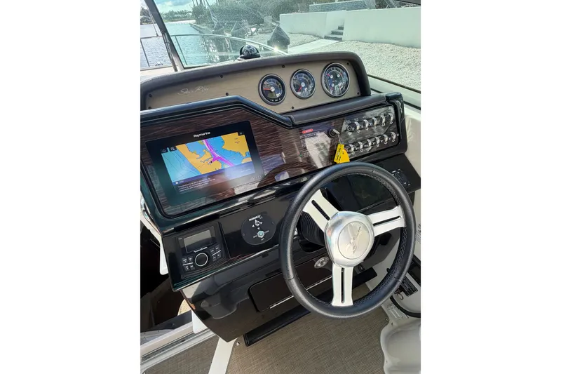 Slide: The Image of Cockpit of 2018 Sea Ray Sundancer 260 with navigation display and steering wheel. - 54