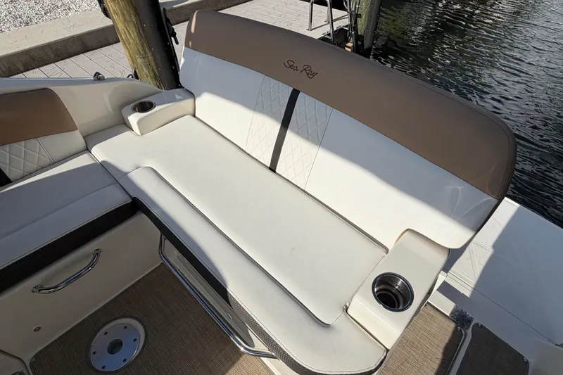 Slide: The Image of 2018 Sea Ray Sundancer 260 boat seating area with cup holders by the water. - 57