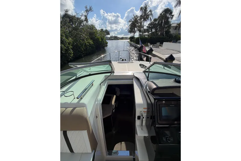 Slide: The Image of 2018 Sea Ray Sundancer 260 cruising on a scenic waterway with lush greenery. - 59