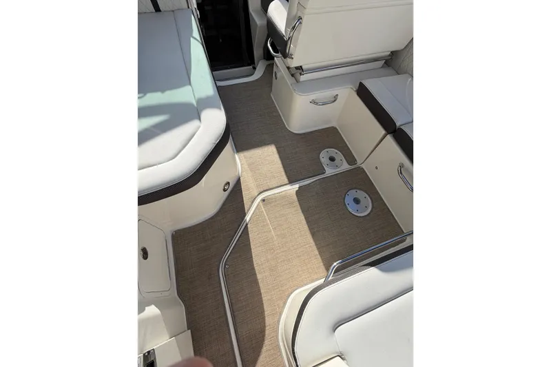 Slide: The Image of Interior view of 2018 Sea Ray Sundancer 260 boat with cushioned seating and carpeted flooring. - 62