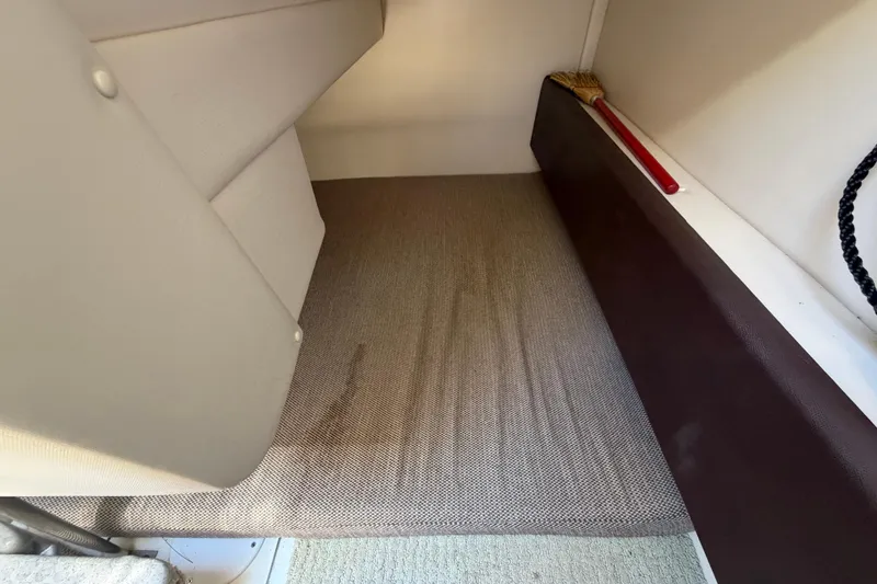 Slide: The Image of Interior cabin of 2018 Sea Ray Sundancer 260 with carpet and broom. - 68