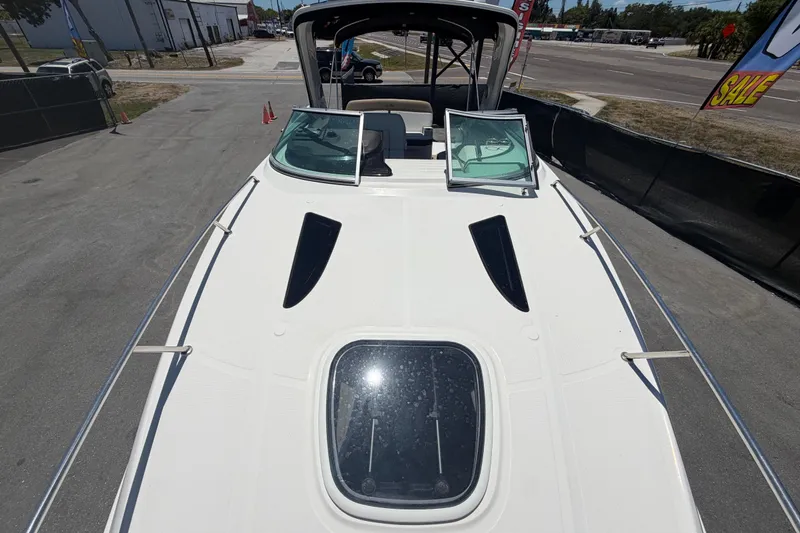 Slide: The Image of 2018 Sea Ray Sundancer 260 boat deck with open windows, parked outdoors. - 75