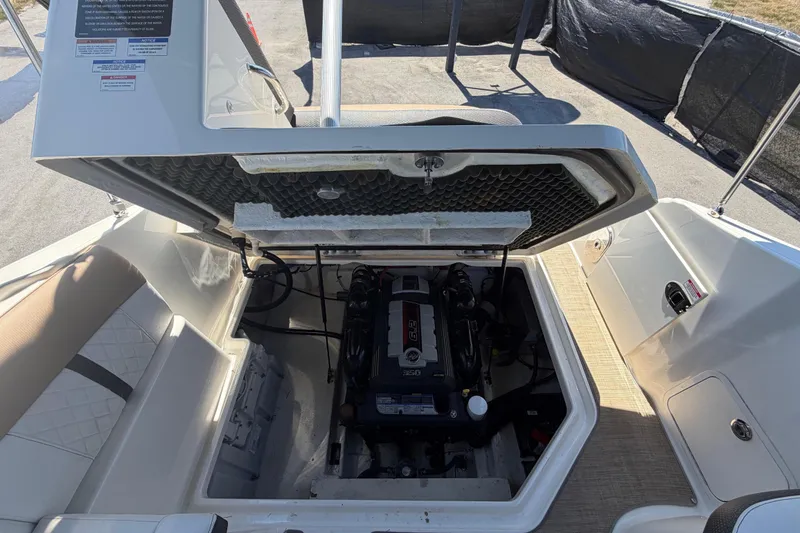 Slide: The Image of 2018 Sea Ray Sundancer 260 engine compartment with open hatch, showcasing the engine details. - 88