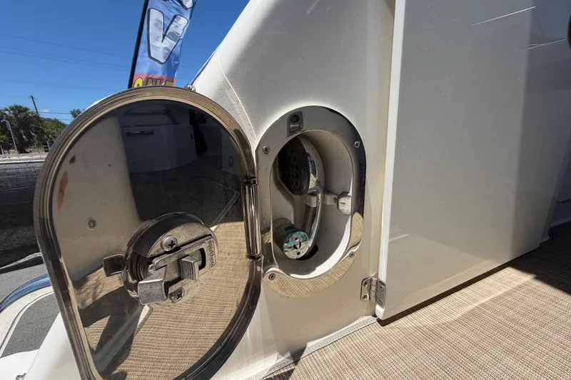 Slide: The Image of 2018 Sea Ray Sundancer 260 boat detail showing a metallic hatch and fittings. - 96