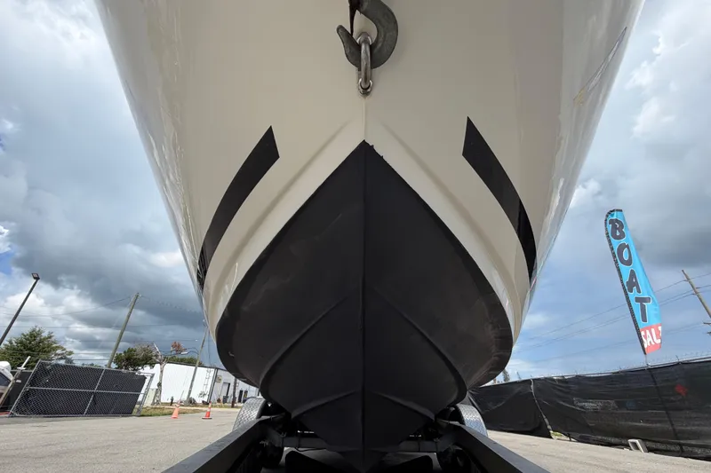 Slide: The Image of 2018 Sea Ray Sundancer 260 boat hull, displayed outdoors at a boat sale event. - 13