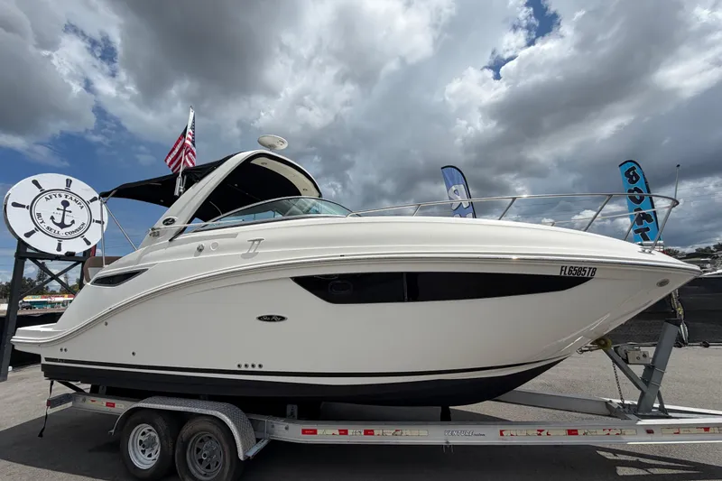 The Image of 2018 Sea Ray Sundancer 260 boat on trailer under cloudy sky. - 0