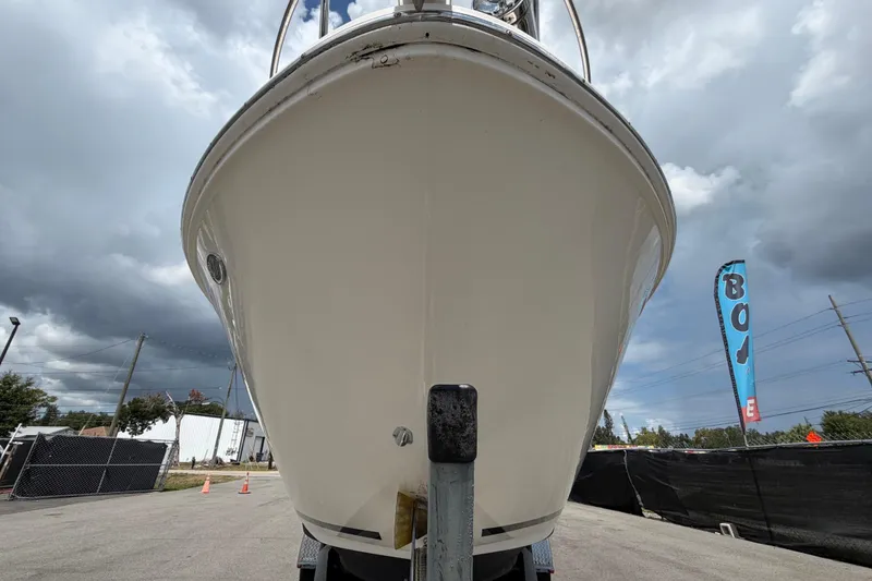 Slide: The Image of Bow view of a Sea Ray Sundancer 260 on a trailer, with cloudy sky in the background. - 11