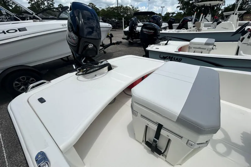 Slide: The Image of 2026 Mako Pro Skiff 15 CC boat with Mercury outboard motor, docked in marina. - 5