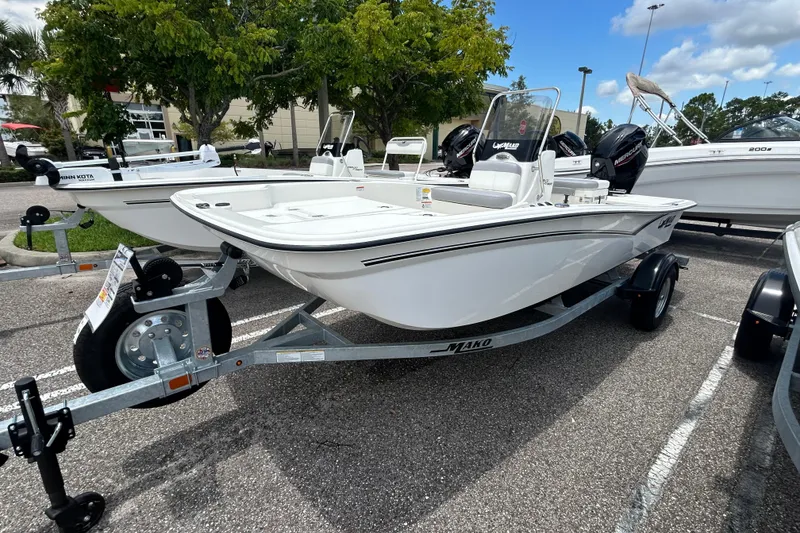 The Image of 2026 Mako Pro Skiff 15 CC boat on trailer in parking lot. - 0