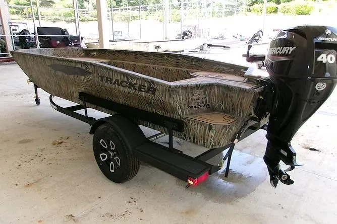 Slide: The Image of 2026 Tracker Grizzly 1650 T Prairie Wings Edition boat with Mercury 40 engine on trailer. - 2