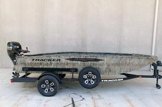 The Image of 2026 Tracker Grizzly 1650 T Prairie Wings Edition boat on trailer, camouflage design. - 0