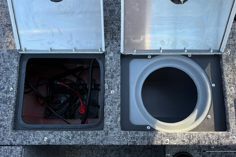 Slide: The Image of Open compartments on a 2026 Tracker Pro Guide V-175 WT boat, showing wiring and storage. - 43