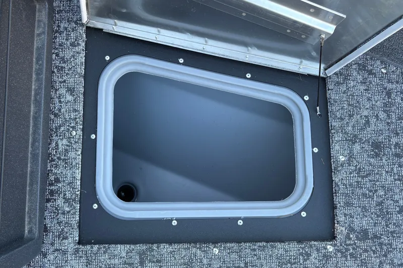 Slide: The Image of 2026 Tracker Pro Guide V-175 WT boat storage compartment with open hatch. - 27