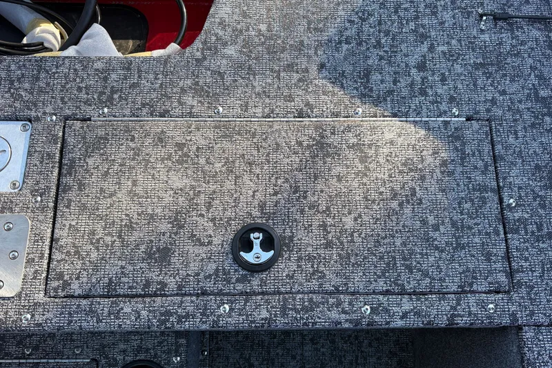 Slide: The Image of 2026 Tracker Pro Guide V-175 WT boat deck with textured surface and storage compartment. - 35