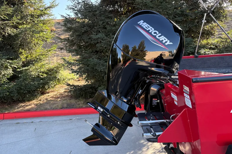 Slide: The Image of 2026 Tracker Pro Guide V-175 WT with Mercury outboard motor, parked outdoors. - 13