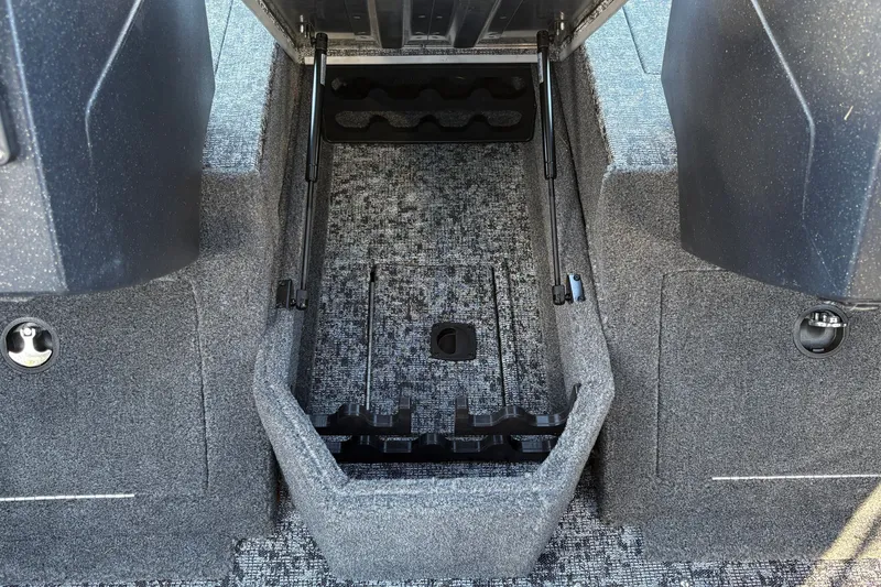 Slide: The Image of 2026 Tracker Pro Guide V-175 WT boat storage compartment with carpeted interior and organized layout. - 32