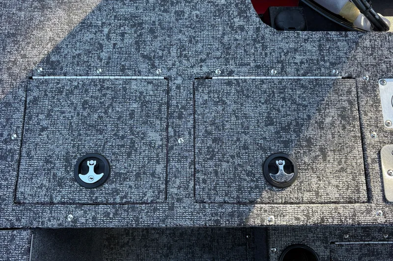 Slide: The Image of 2026 Tracker Pro Guide V-175 WT boat deck with storage compartments and textured surface. - 34