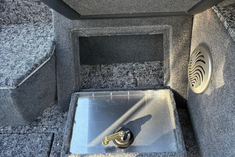 Slide: The Image of Interior of 2026 Tracker Pro Guide V-175 WT boat with speaker and storage compartment. - 28