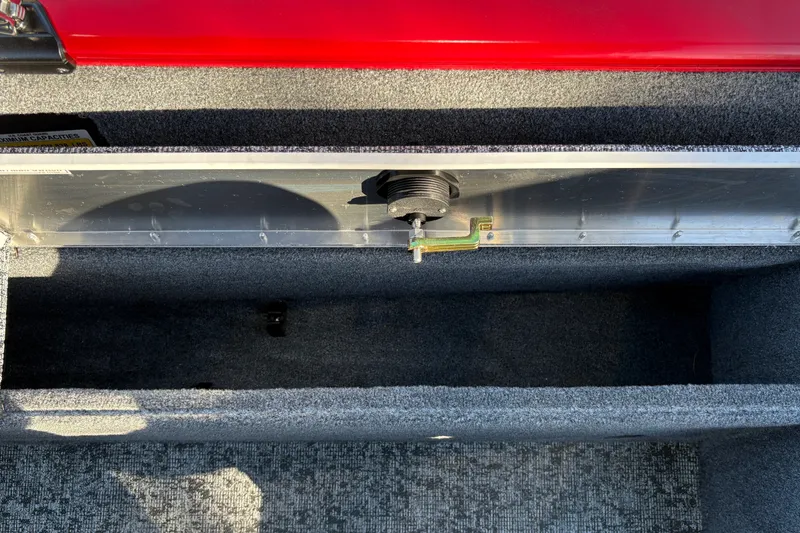 Slide: The Image of Storage compartment of 2026 Tracker Pro Guide V-175 WT boat, featuring carpeted interior. - 42