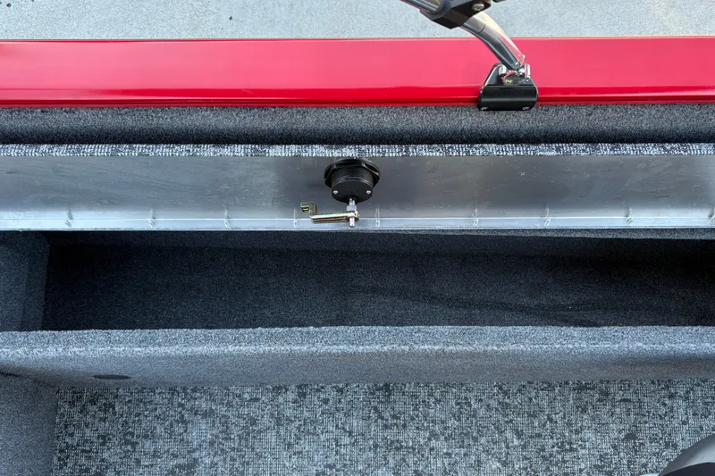 Slide: The Image of 2026 Tracker Pro Guide V-175 WT boat interior storage compartment with red trim and carpeted finish. - 38