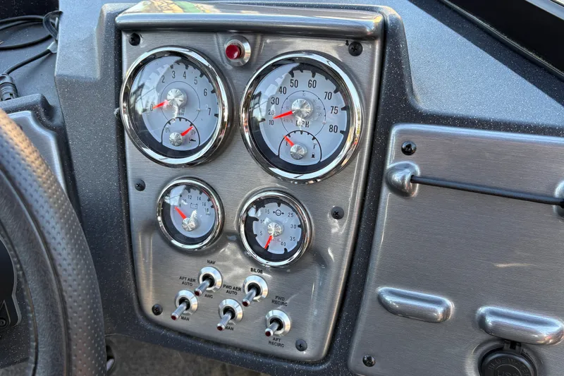Slide: The Image of Dashboard of 2026 Tracker Pro Guide V-175 WT with gauges and switches. - 24