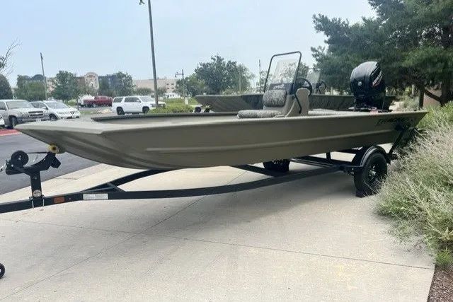 The Image of 2026 Tracker Grizzly 1860 CC boat on trailer, parked outdoors. - 0