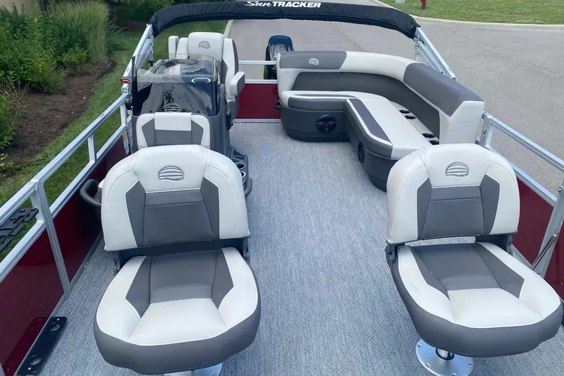 Slide: The Image of 2026 Sun Tracker Bass Buggy 16 XL Select pontoon boat interior with seating and helm. - 3