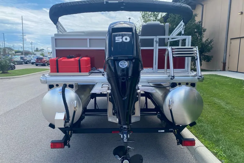 Slide: The Image of 2026 Sun Tracker Bass Buggy 16 XL Select pontoon boat with 50 HP motor, rear view. - 2