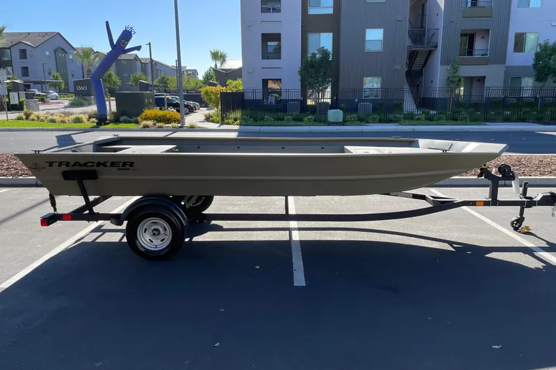 The Image of 2026 Tracker Grizzly 1860 Utility boat on trailer in parking lot. - 0