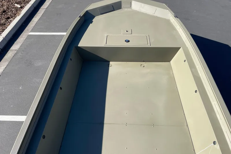Slide: The Image of 2026 Tracker Grizzly 1860 Utility boat interior, showcasing spacious deck and storage compartment. - 7