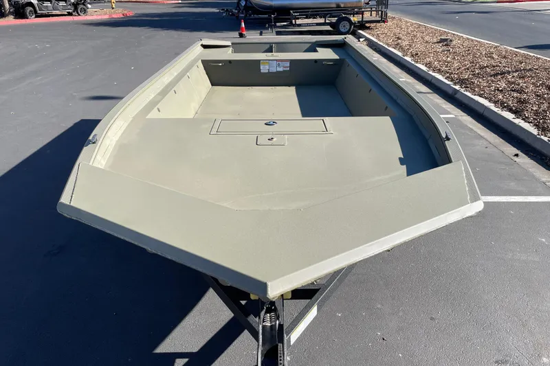 Slide: The Image of 2026 Tracker Grizzly 1860 Utility boat on trailer in parking lot. - 3