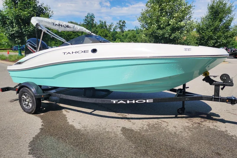 The Image of 2026 Tahoe T16 boat on trailer, mint green hull, parked outdoors. - 0