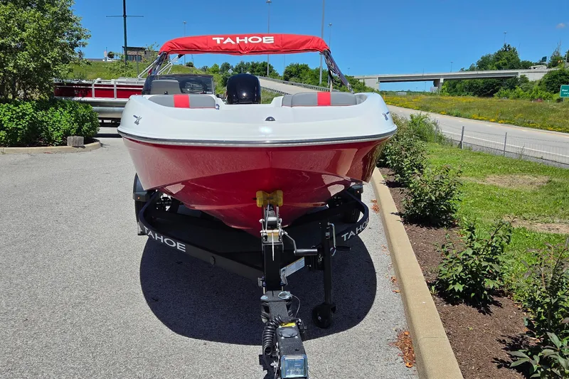 Slide: The Image of 2026 Tahoe T16 boat on trailer, red and white design, parked outdoors on sunny day. - 3