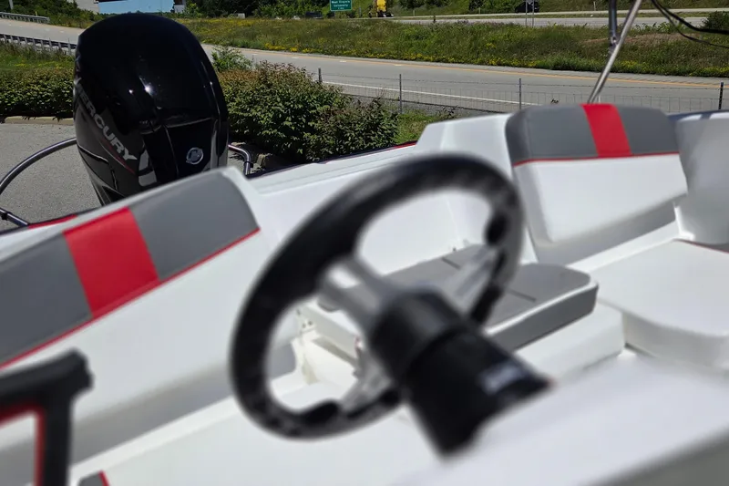 Slide: The Image of 2026 Tahoe T16 boat interior with steering wheel and Mercury engine. - 6