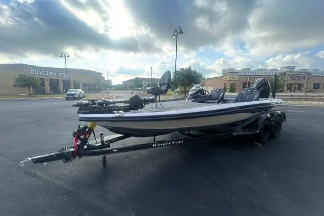 Slide: The Image of 2026 Ranger Z521R boat on trailer in parking lot, cloudy sky background. - 2