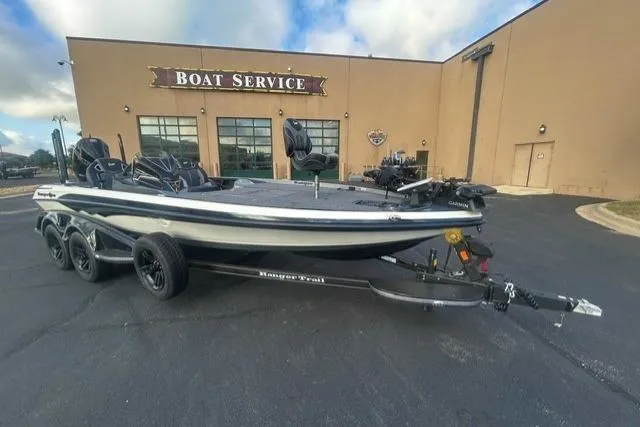Slide: The Image of 2026 Ranger Z521R boat parked outside a boat service center on a sunny day. - 1