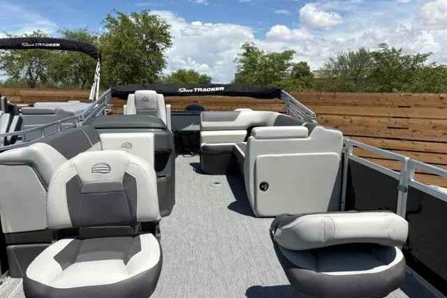 Slide: The Image of 2026 Sun Tracker Fishin' Barge 22 DLX pontoon boat with spacious seating and modern design. - 2