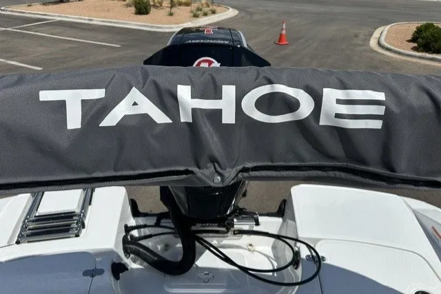 Slide: The Image of 2026 Tahoe 1950 boat with protective cover in parking lot. - 20