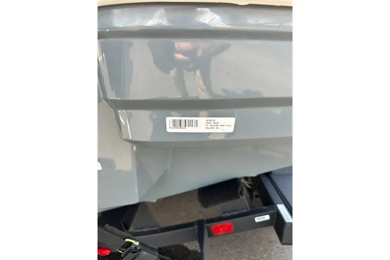 Slide: The Image of 2026 Tahoe 1950 boat with barcode sticker on gray hull. - 25