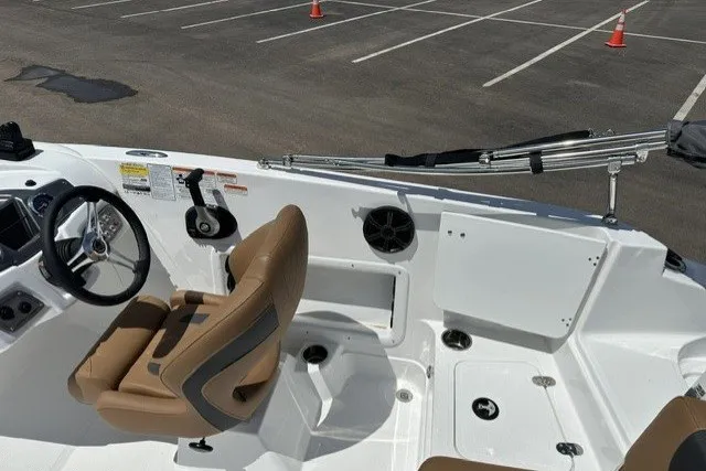 Slide: The Image of Interior of a 2026 Tahoe 1950 boat with tan seating and steering wheel. - 15