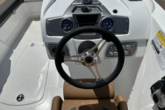 Slide: The Image of Steering console of a 2026 Tahoe 1950 boat with modern controls and gauges. - 16