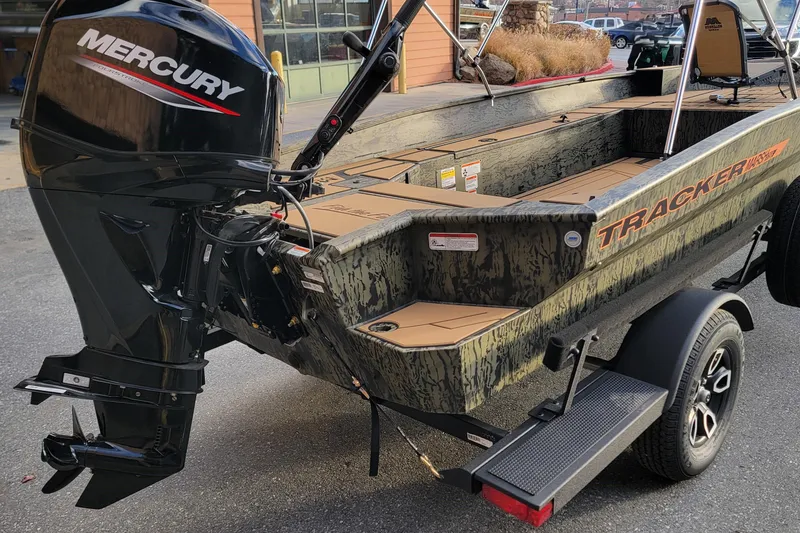 Slide: The Image of 2026 Tracker Grizzly 1756 T Marsh boat with Mercury outboard motor, parked on trailer. - 3