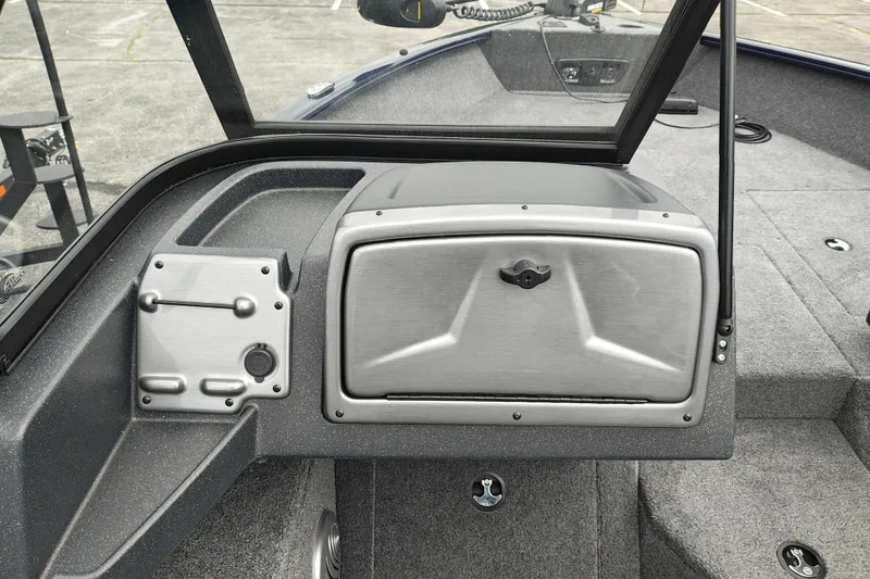Slide: The Image of 2026 Tracker Pro Guide V-175 WT boat interior with storage compartment and control panel. - 10