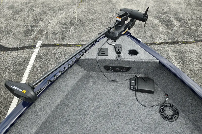 Slide: The Image of 2026 Tracker Pro Guide V-175 WT boat with Minn Kota trolling motor on carpeted deck. - 12