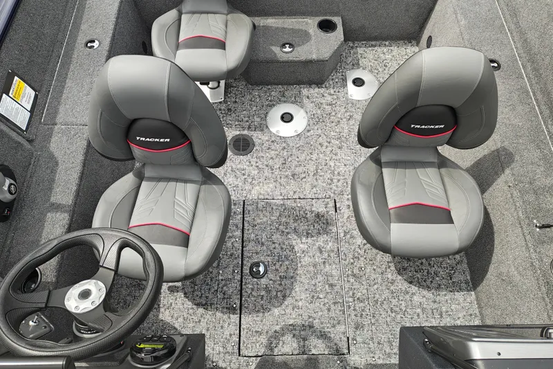 Slide: The Image of 2026 Tracker Pro Guide V-175 WT boat interior with gray seating and steering wheel. - 16