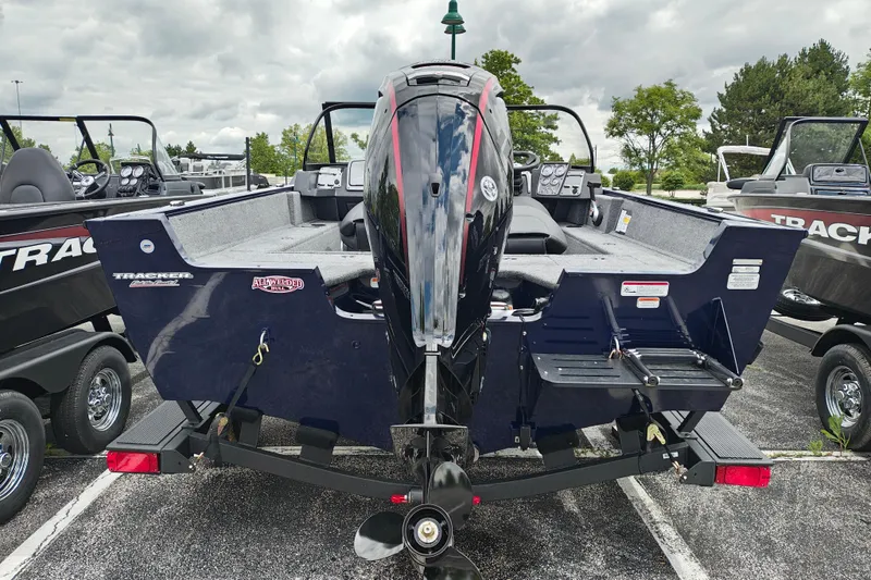 Slide: The Image of 2026 Tracker Pro Guide V-175 WT boat, rear view, parked outdoors on a trailer. - 2
