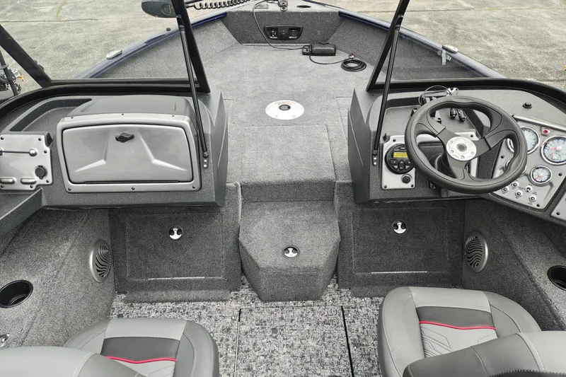 Slide: The Image of Interior of 2026 Tracker Pro Guide V-175 WT boat, featuring steering console and seating. - 7
