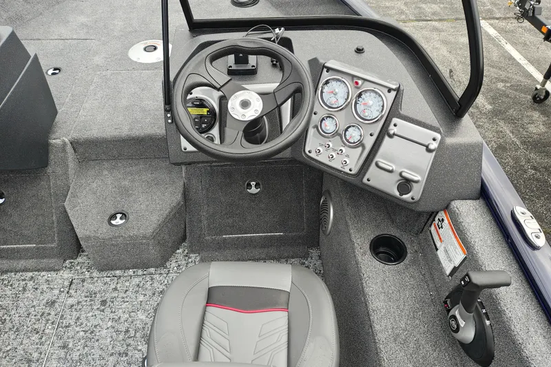 Slide: The Image of Interior of 2026 Tracker Pro Guide V-175 WT boat, featuring steering wheel and control panel. - 8