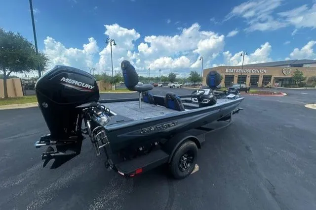 Slide: The Image of 2026 Ranger RT178 boat with Mercury engine at a service center under a blue sky. - 3