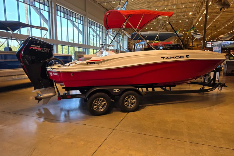 The Image of 2026 Tahoe T21 boat with red hull and canopy on display indoors. - 0